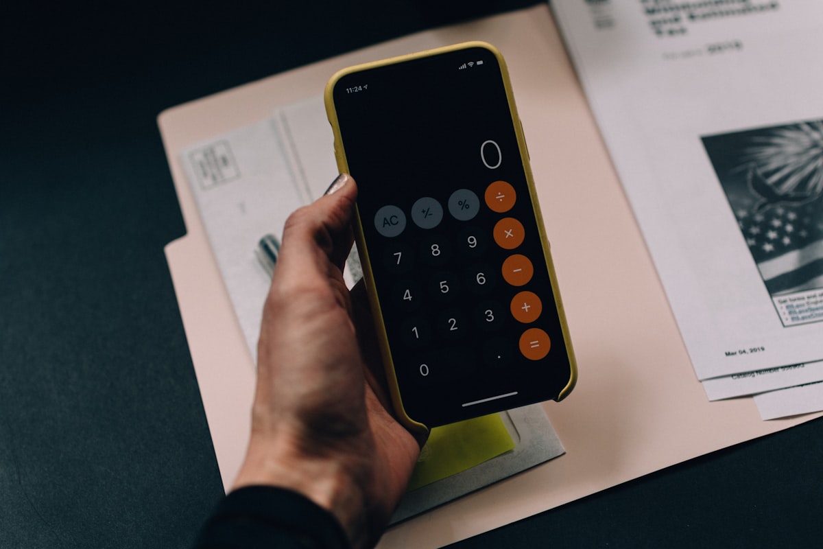 Accountant using a calculator to verify tax figures